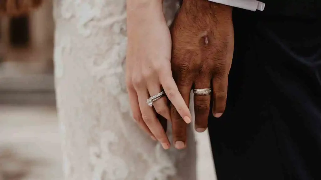newly married couple holding hands on wedding day