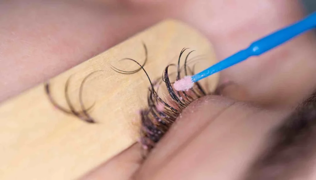 someone having their eyelash extensions removed